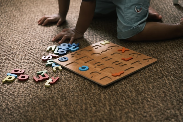 Child learning with a letter puzzle